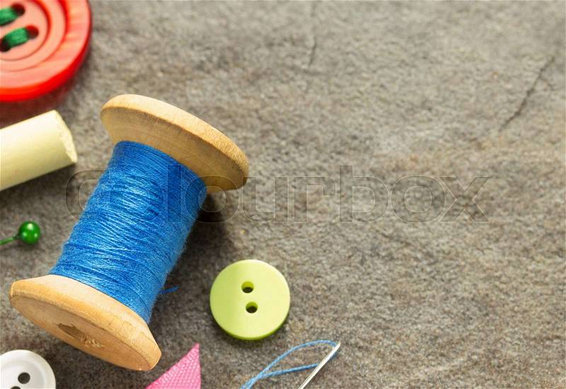Sewing tools and accessories on table background, stock photo