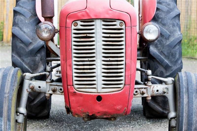 Old tractor face, red, rusty an dented, stock photo