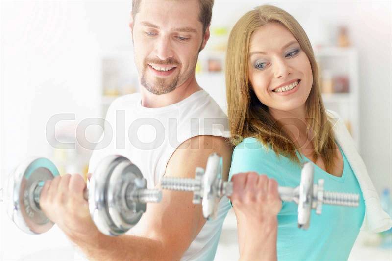Portrait of a happy attractive couple at the gym, stock photo