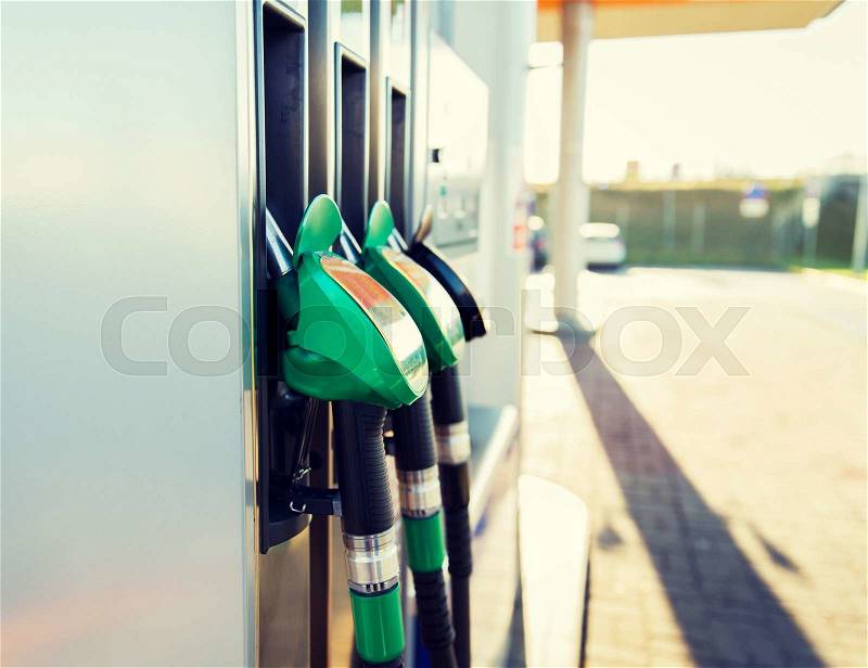 Object, fuel, oil, tank and transport concept - close up of gasoline hose at gas station, stock photo