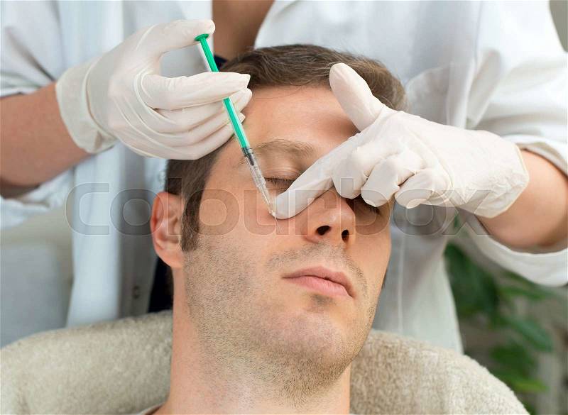 Handsome man is getting injection. Concept of aesthetic beauty, stock photo