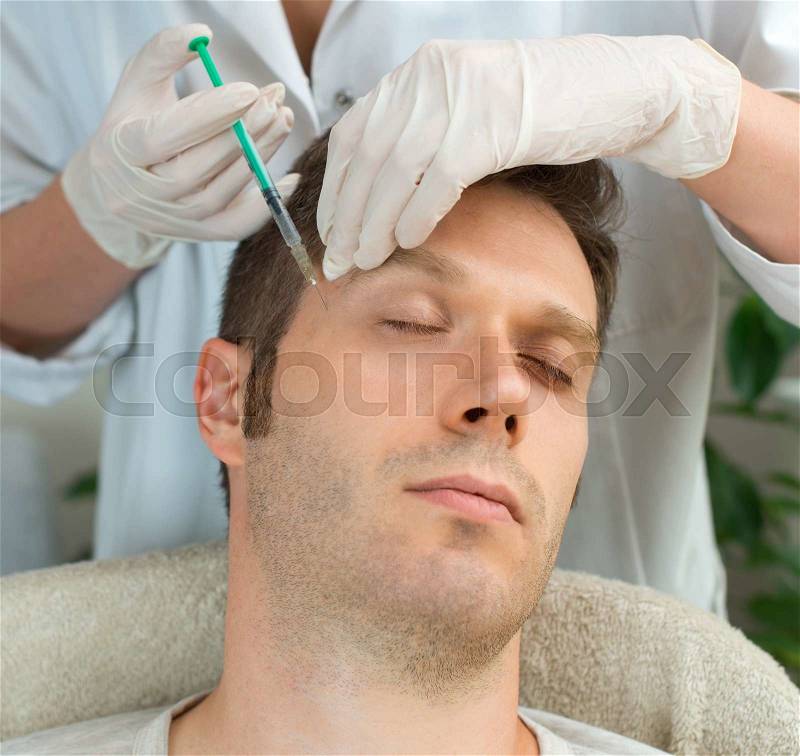 Handsome man is getting injection. Concept of aesthetic beauty, stock photo