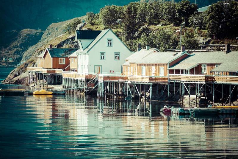 Typical Norwegian fishing village with traditional red rorbu huts, Reine, Lofoten Islands, Norway, stock photo