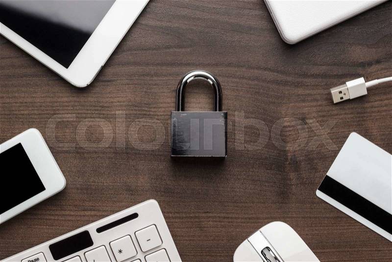 Padlock and different gadgets on the wooden office table. privacy protection, encrypted connection concept, buying online, stock photo