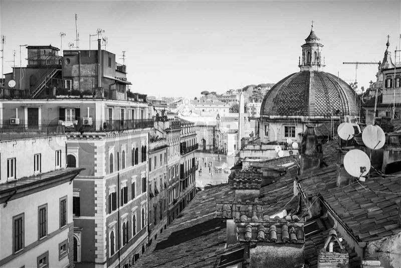 Old Rome, Italy. Via del Corso street view, black and white photo taken from the roof, looking on The Piazza del Popolo with dome of Basilica Santa Maria di Montesanto as a dominant landmark, stock photo