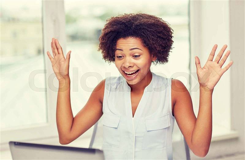 Education, business and technology concept - happy african american businesswoman or student with laptop computer at office, stock photo
