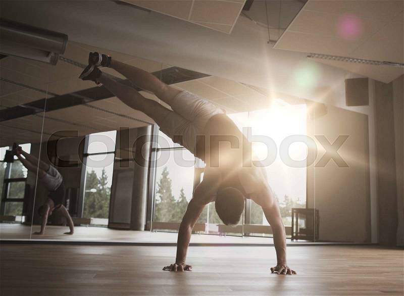 Sport, fitness, lifestyle and people concept - man exercising in gym, stock photo