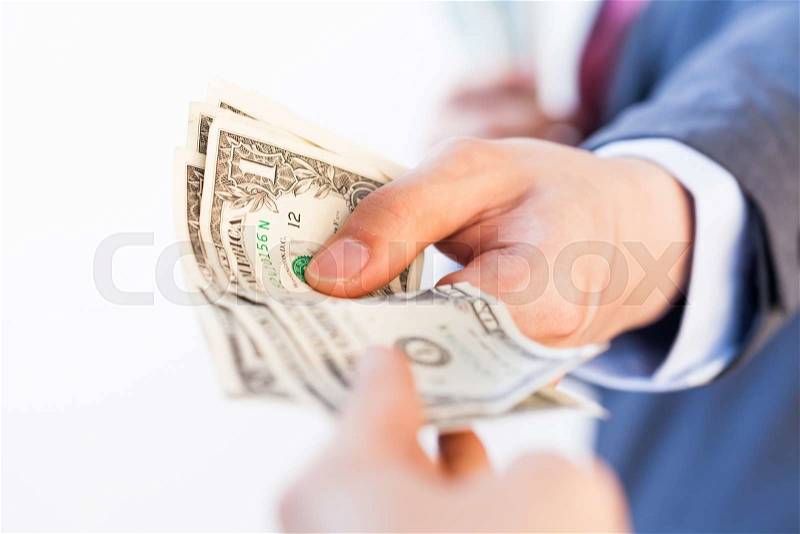Business man giving bank notes to another person. Corruption and Payment concept, stock photo