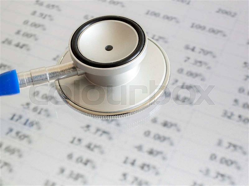 Stethoscope on financial data - indicates to check and diagnose about finance (selectively focus on stethoscope, blurred out the data), stock photo