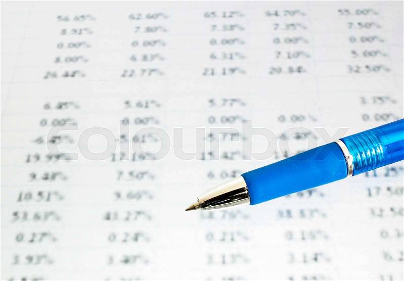 Blue pen on financial data (focus on pen, blurred out the data), stock photo