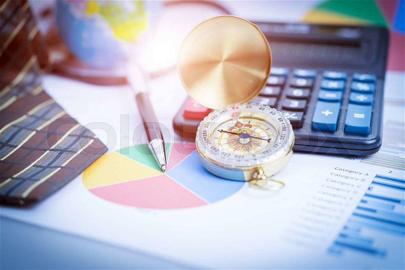 Business analyzing investment charts with laptop, calculator, pen, compass. Accounting. Vintage filtered, stock photo