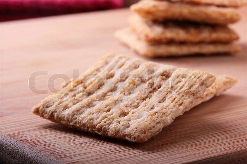 Wheat crackers on a kitchen board - a light meal, stock photo