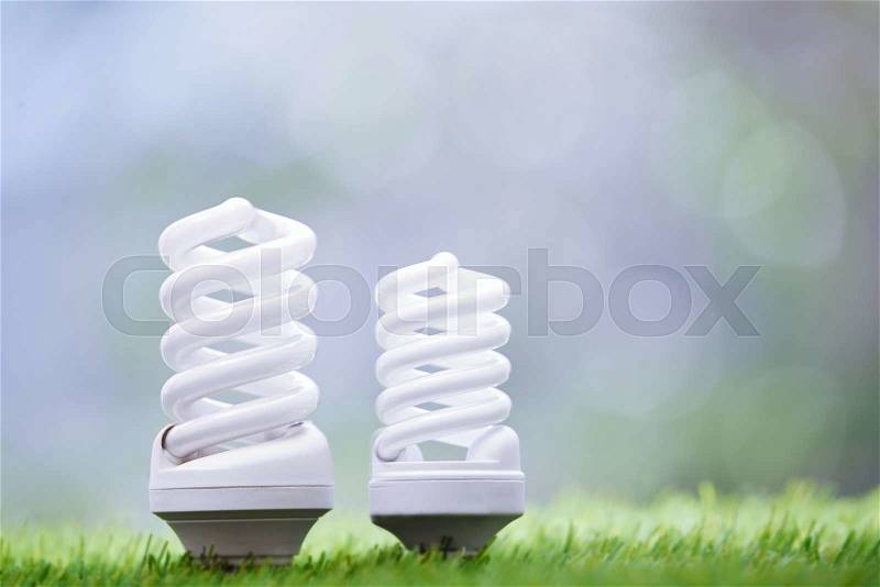 Energy saving bulbs in the grass. Close-up photo, stock photo