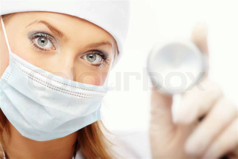 Doctor in protective mask and rubber gloves holding stethoscope, stock photo