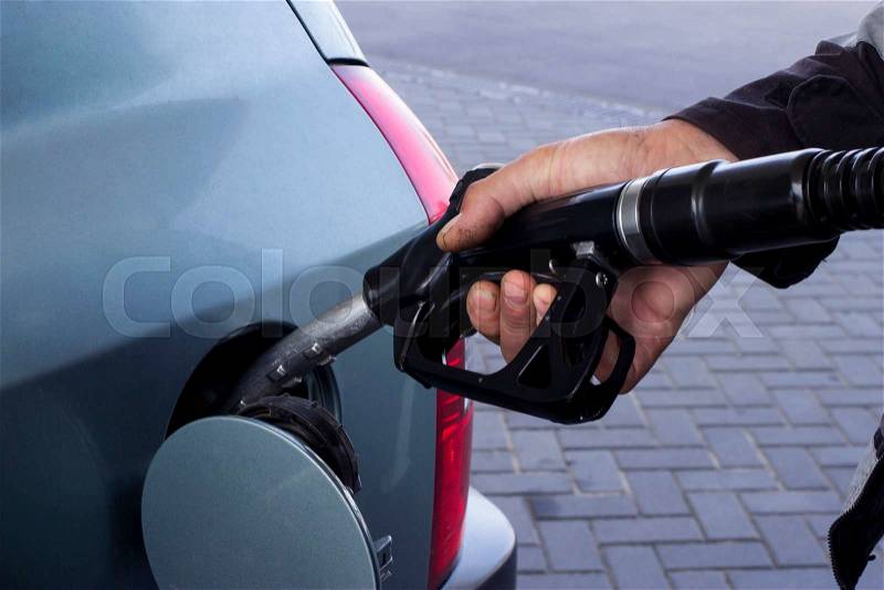Car fill with gasoline at a gas station, stock photo
