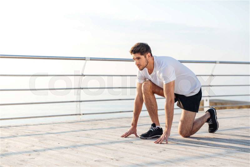 Confident young sportsman is ready to run in the morning, stock photo