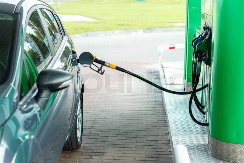 Car refueling on a petrol station closeup, stock photo
