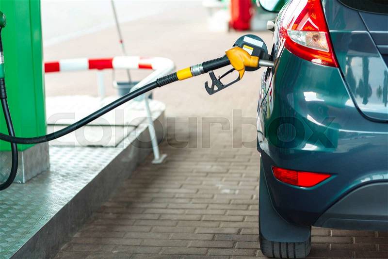 Car refueling on a petrol station closeup, stock photo