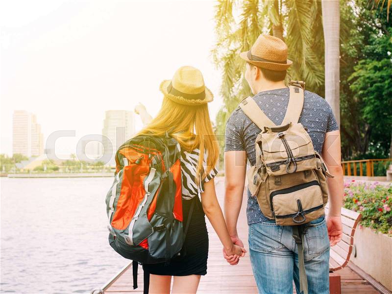 Couple travelers walking and holding hands together - Journey of love and travel, stock photo