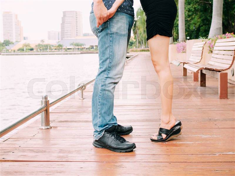 Couple of Male and female legs during a kissing date - love and relationship concept, stock photo