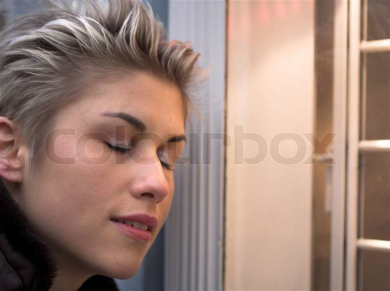 Woman outdoor in a city on shopping tour closed eyes, stock photo