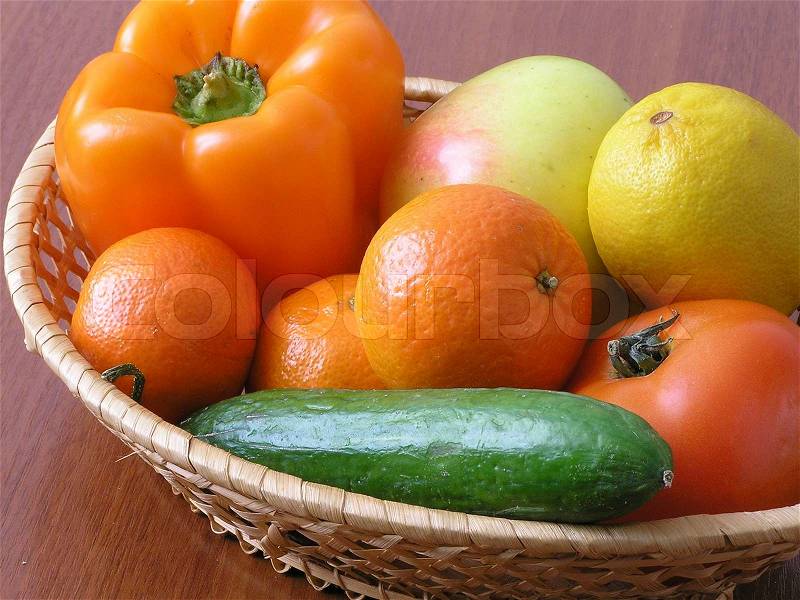 On a photo a basket in which different vegetables and fruit. The photo is made in Ukraine, stock photo