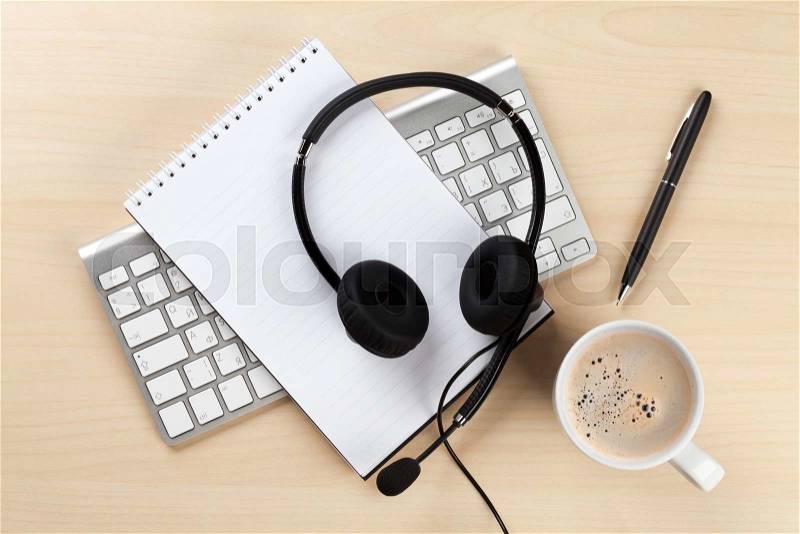 Office desk with headset and pc. Call center support table. Top veiw, stock photo
