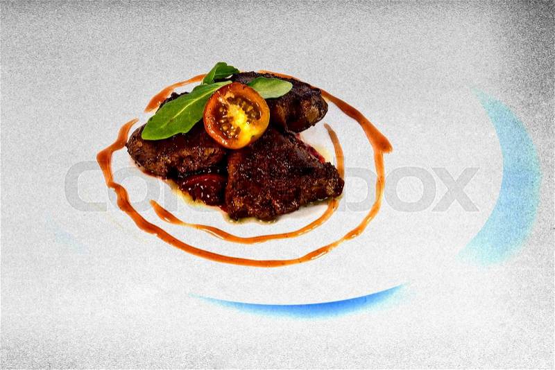 Modern food on a white plate and blue background - grilled goose liver with red onion, stock photo