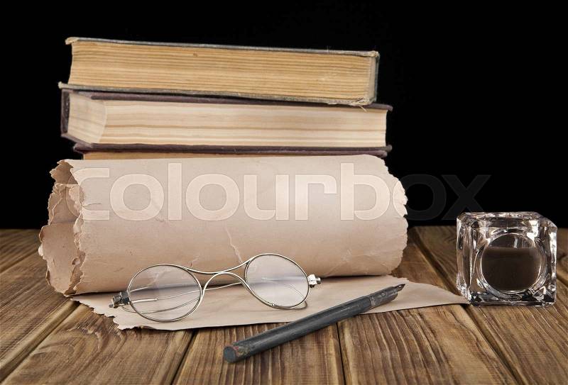 Old glasses, paper and pen on black background, stock photo