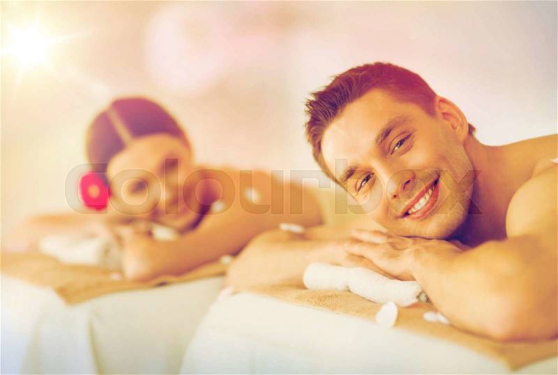 Picture of couple in spa salon lying on the massage desks, stock photo