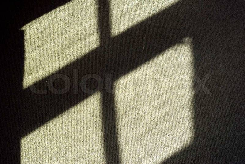 Reflected sunlight and window shadow on carpet, stock photo