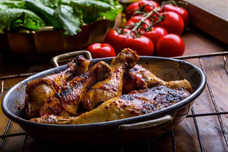 Grilled chicken legs, lettuce and cherry tomatoes limet olives. Traditional cuisine. Mediterranean cuisine, stock photo