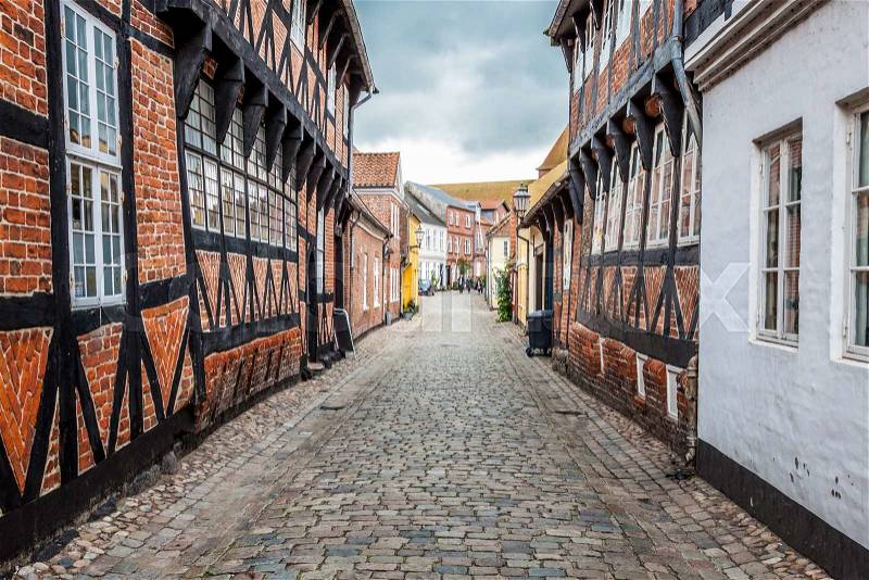 Street with old houses from royal town Ribe in Denmark, stock photo