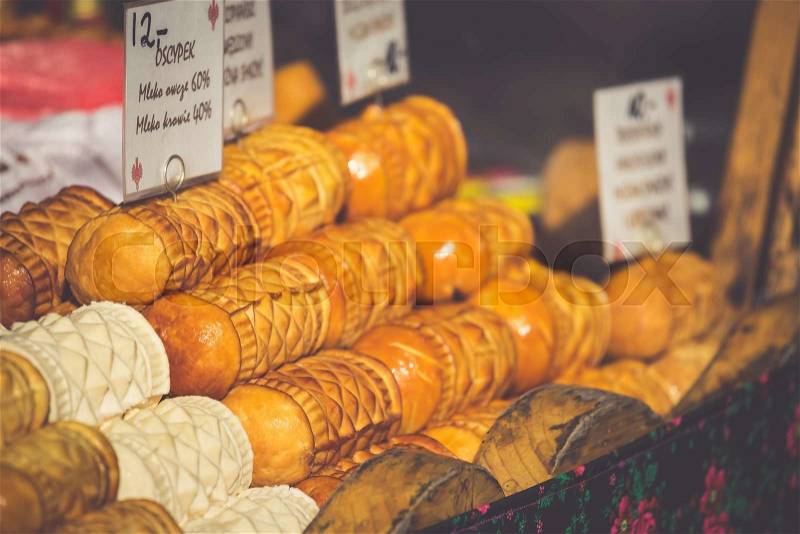 Traditional polish smoked cheese oscypek on outdoor market in Zakopane, stock photo