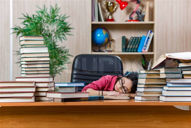 Young female student preparing for college school exams, stock photo