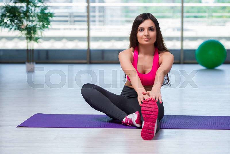 Young woman doing exercises in gym health concept, stock photo