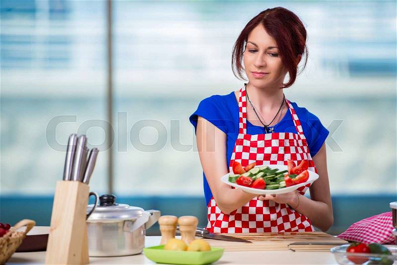 Young woman working in the kitchen, stock photo