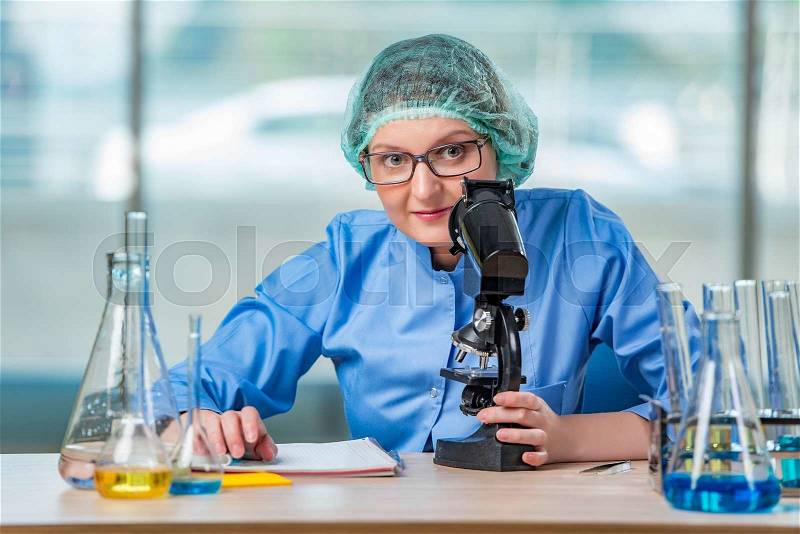 Experienced lab assistant working on chemical solutions, stock photo