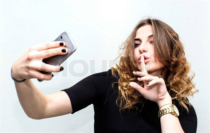 Girl doing self phone on a white background, stock photo