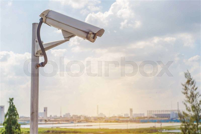 Security CCTV camera on road in city, stock photo