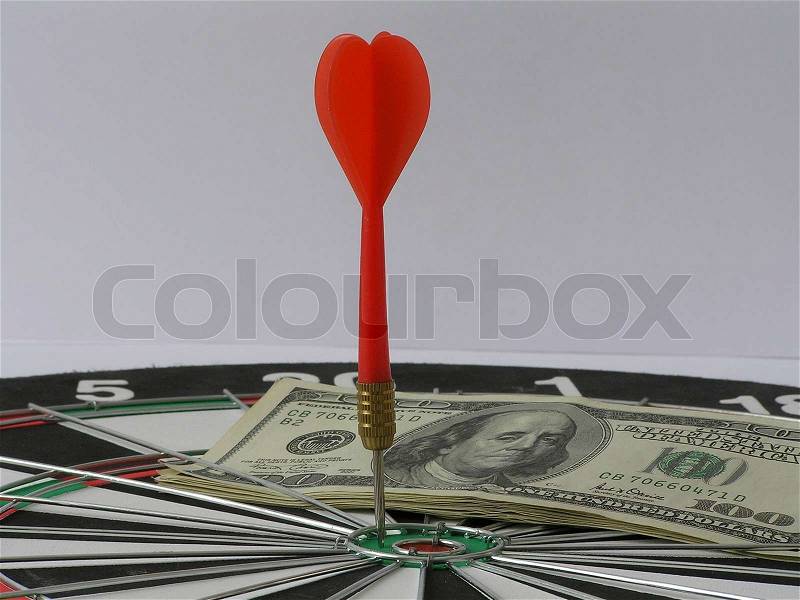 On a photo a board for a darts. On which money and darts. The photo is isolated. The photo is made in Ukraine, stock photo