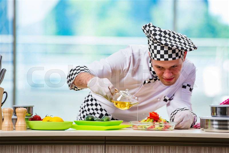 Male cook preparing food in the kitchen, stock photo