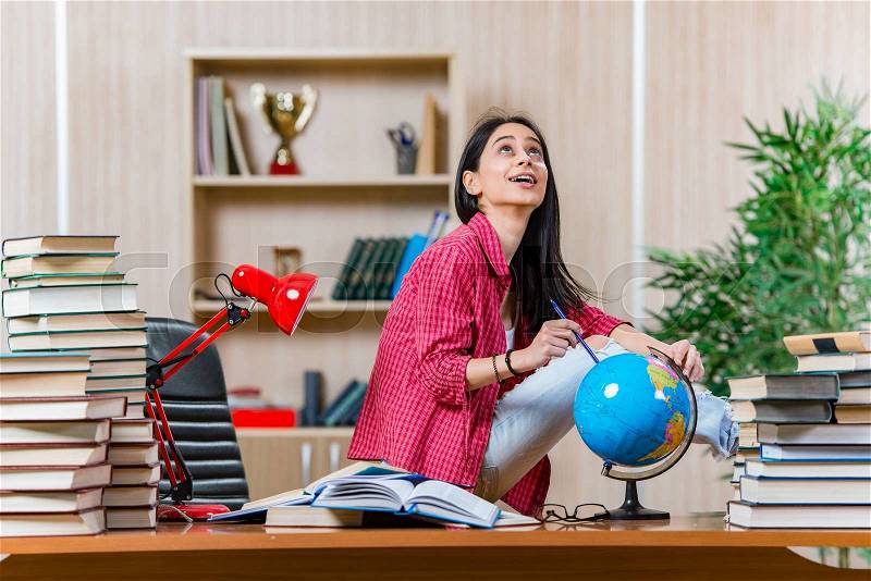 Young female student preparing for college school exams, stock photo