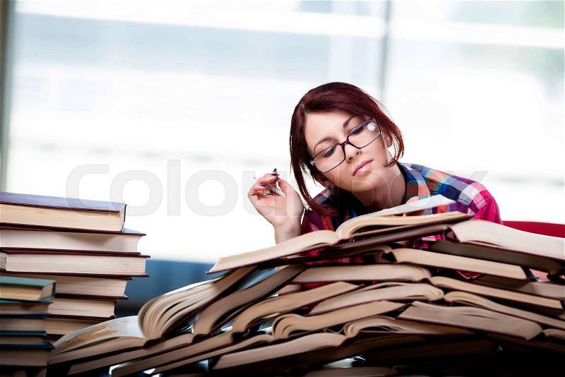 Young woman student preparing for college exams, stock photo