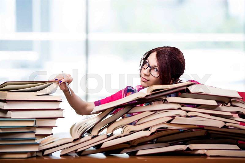 Young woman student preparing for college exams, stock photo