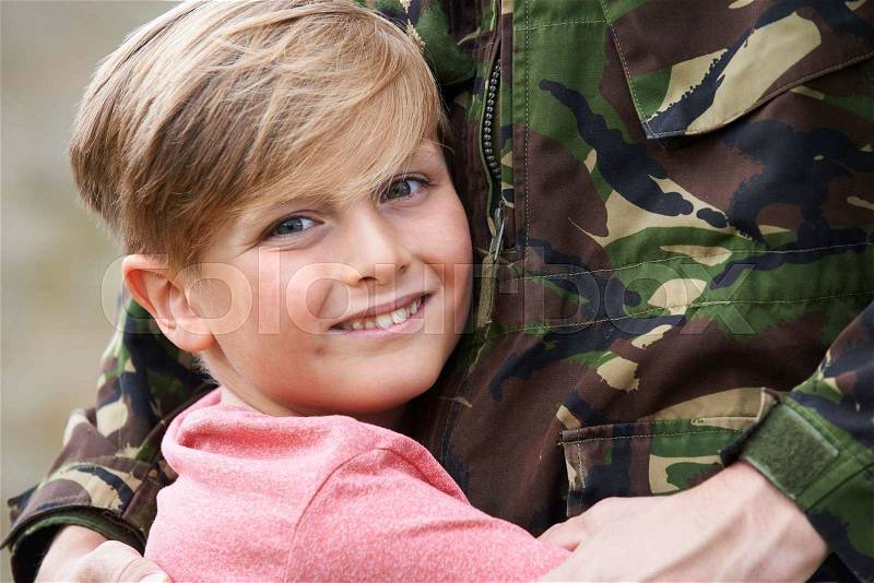 Son Hugging Military Father Home On Leave, stock photo
