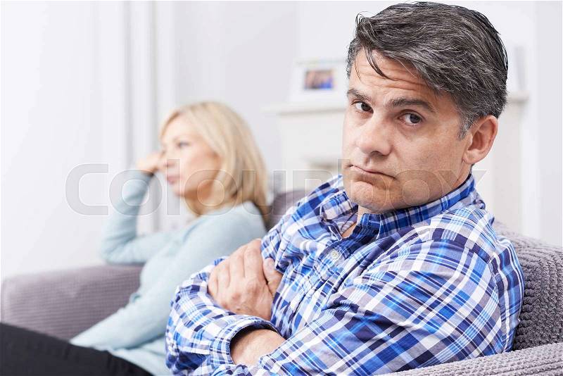 Couple With Relationship Difficulties Sitting On Sofa, stock photo