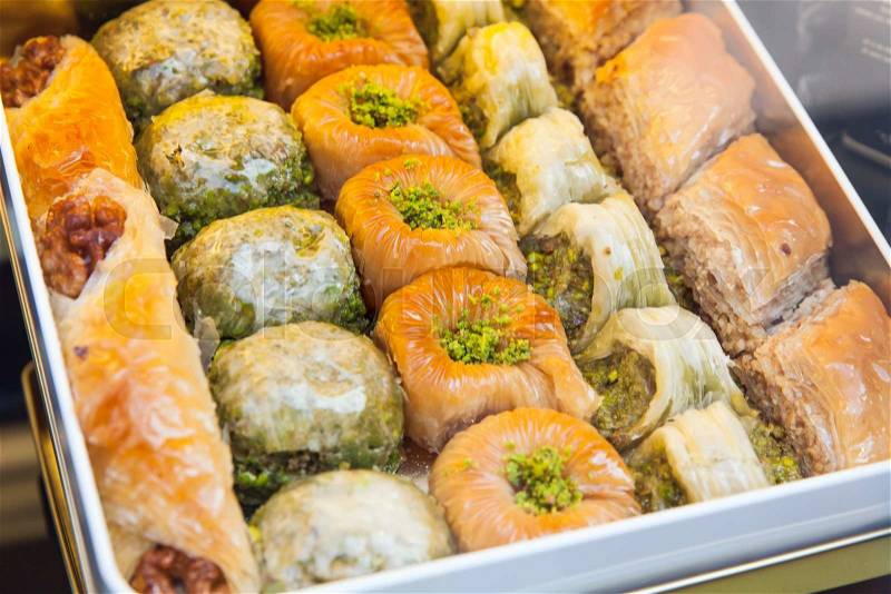 Baklava in metal box, it is sweet pastry made of layers of filo with chopped nuts and sweetened and held together with syrup or honey. Photo with selective focus, stock photo