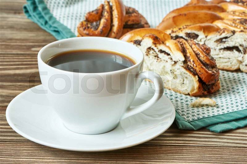 Cup of black coffee and poppy seed cake on napkin, stock photo