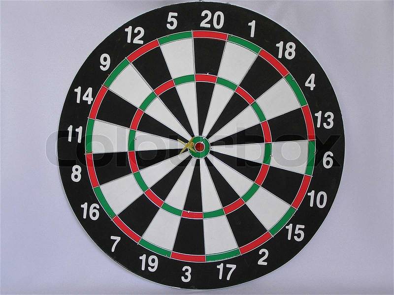 On a photo game of a darts. The target of different colors is divided into sector. In the center darts. The photo is made in Ukraine, stock photo